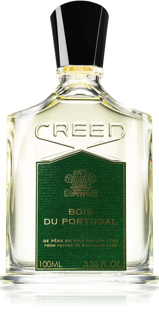 Creed Bois du Portugal bottle with black cap placed beside a plain brown tester box