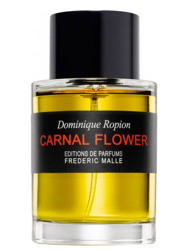 Frédéric Malle Carnal Flower tester with intense golden liquid and glossy black cap on clear glass