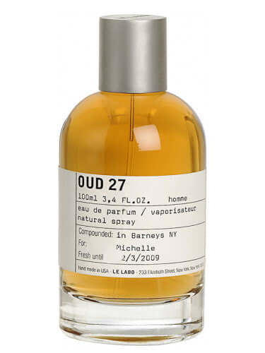 Le Labo Oud 27 tester bottle with silver cap and amber liquid, white background