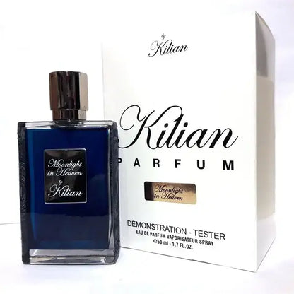 Kilian Moonlight In Heaven bottle with cap placed in front of opened branded tester packaging