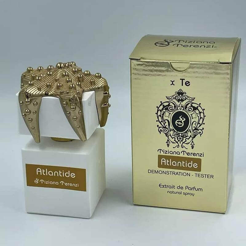 Luxurious Tiziana Terenzi Atlantide tester with ornate crown cap and reflective golden packaging