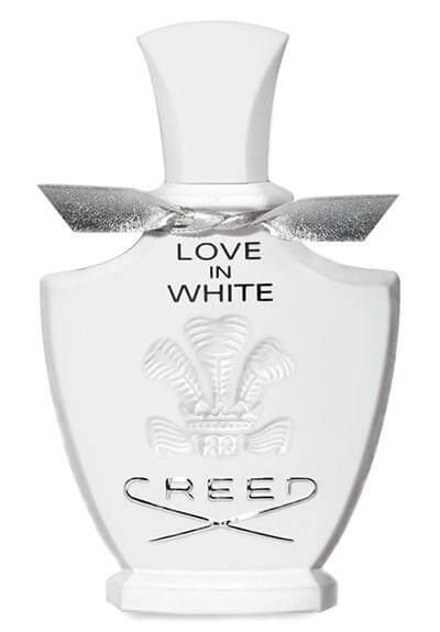 Elegant white Creed Love In White bottle with silver bow and embossed crest, no box shown